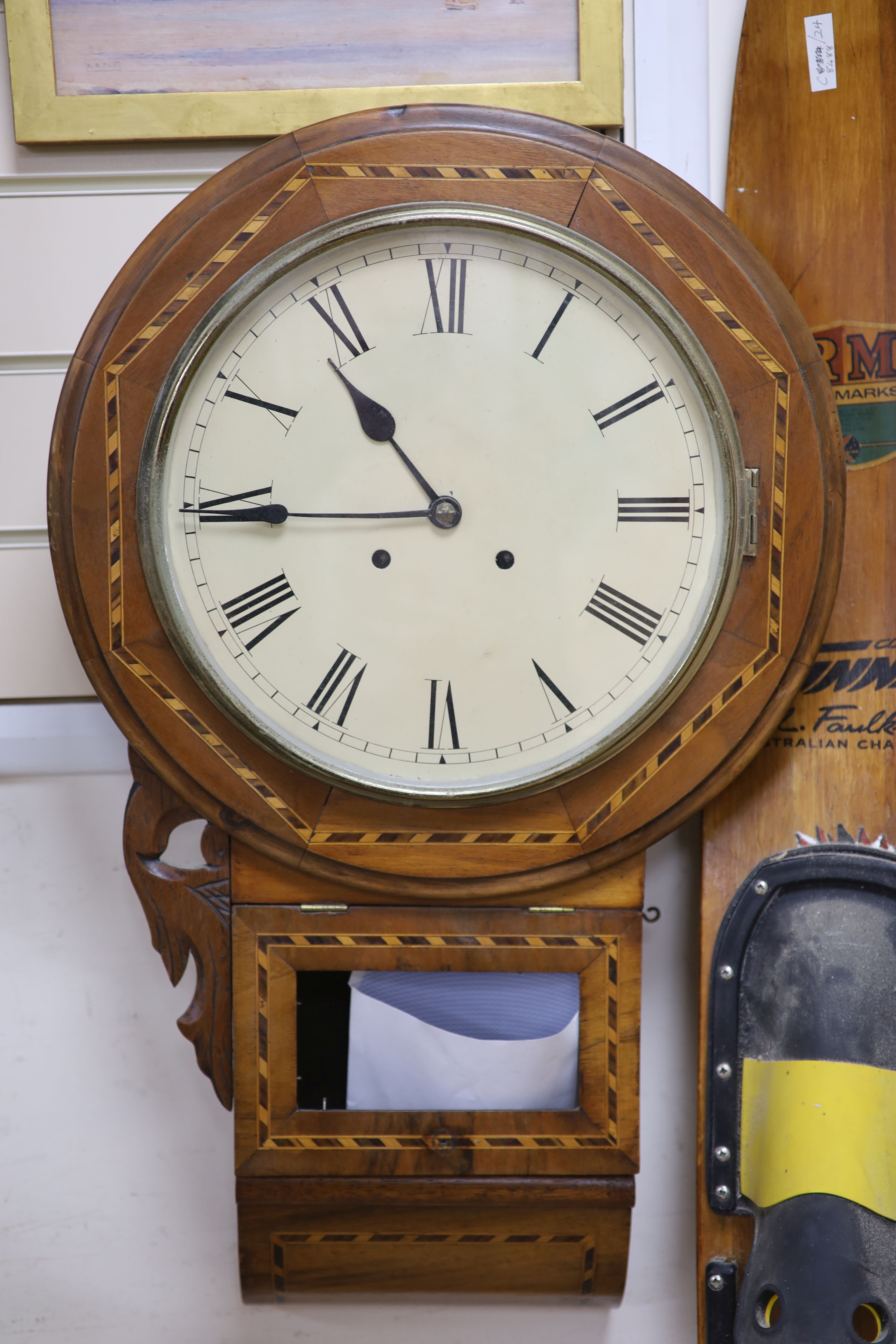 A Victorian inlaid walnut drop dial wall clock, with white enamelled Roman dial, length 75cm